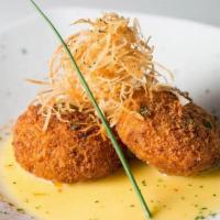 Crab Cakes · Jumbo lump crab breaded and flash fried. Served over a bed of Beurre Fondue sauce and topped...