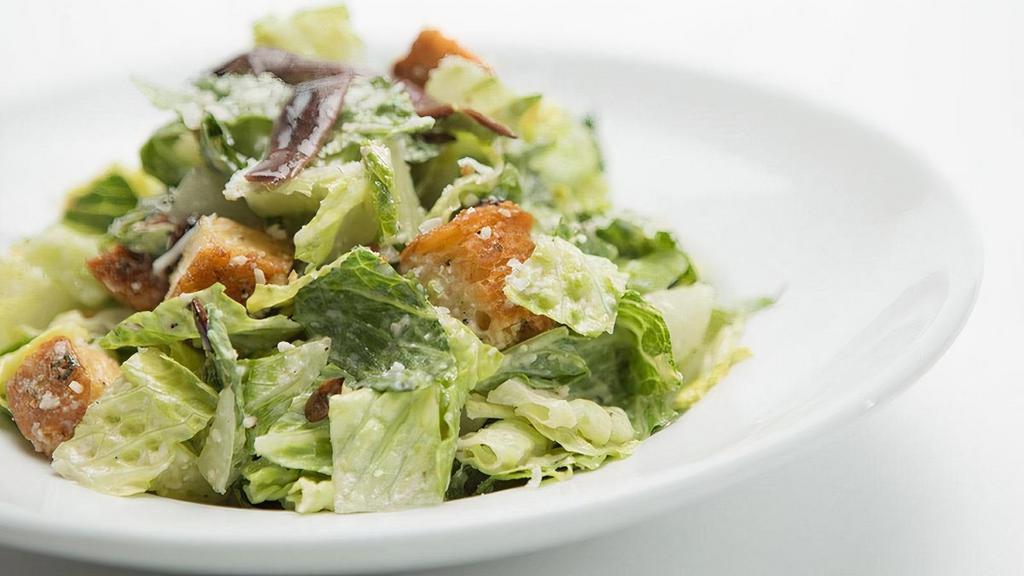 Caesar Salad | Gfm · Romaine lettuce tossed with a creamy Caesar dressing, Romano cheese, roasted pumpkin seeds, homemade croutons and anchovies