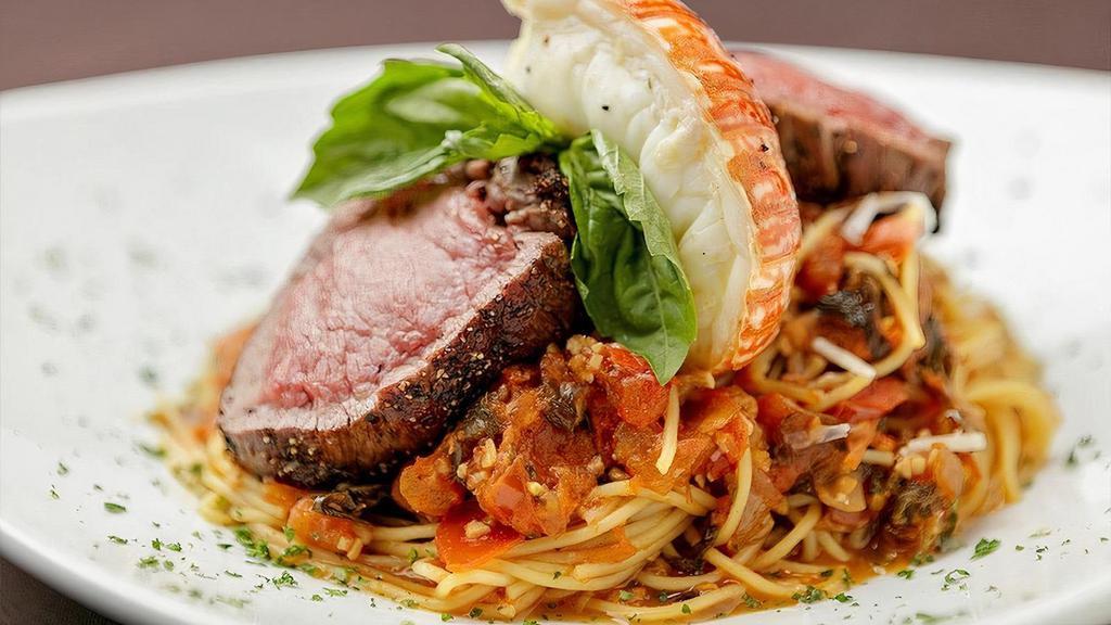 Surf & Turf Pasta* · Six ounces of beef tenderloin tips and 2 ounce of lobster tail. Served over a bed of angel hair pasta tossed in homemade Tomato Basil sauce and topped with shredded Romano cheese.