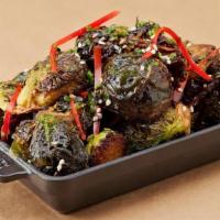 Sweet Sriracha Brussels Sprouts · Fried baby Brussels sprouts, tossed in a sriracha caramel vinaigrette and red bell peppers, ...