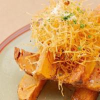 Truffle Steak Fries  · Potato wedges fried, seasoned and topped with truffle oil, potato haystack and parmesan chee...