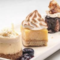 Dessert Trio · A miniature sized chocolate crunch, lemon bar and seasonal cheesecake.