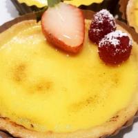 Lemon Berry Tart · Our tangy lemon tart topped with strawberries and light dusting of powdered sugar for that p...