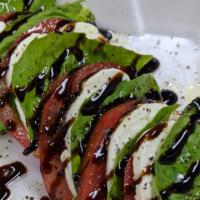 Spinach Salad · Bacon, walnuts, raisins, red onion, & mushrooms on a bed of spinach drizzled with homemade b...