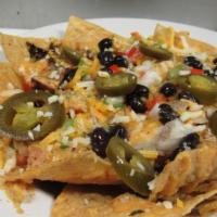 Duckanoo Cheese Nachos · Sauteed shrimp, real crab meat, jalapenos, peppers, onions and mozzarella cheese on a flat b...