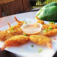 Coconut Shrimp · Breaded in coconut and fried golden. Paired with tropical mango dipping sauce.