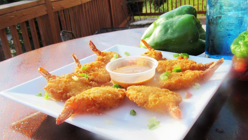 Coconut Shrimp · Breaded in coconut and fried golden. Paired with tropical mango dipping sauce.