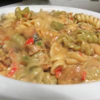 Shrimp Pasta · Tri-color fusilli, peppers, onions, mozzarella cheese, Caribbean herbs and spices and served...