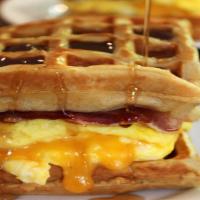 Bistro Breakfast Sandwich · Belgian Waffle, 2 fried eggs, cheese, maple syrup, & choice of meat: bacon/pork sausage/chic...
