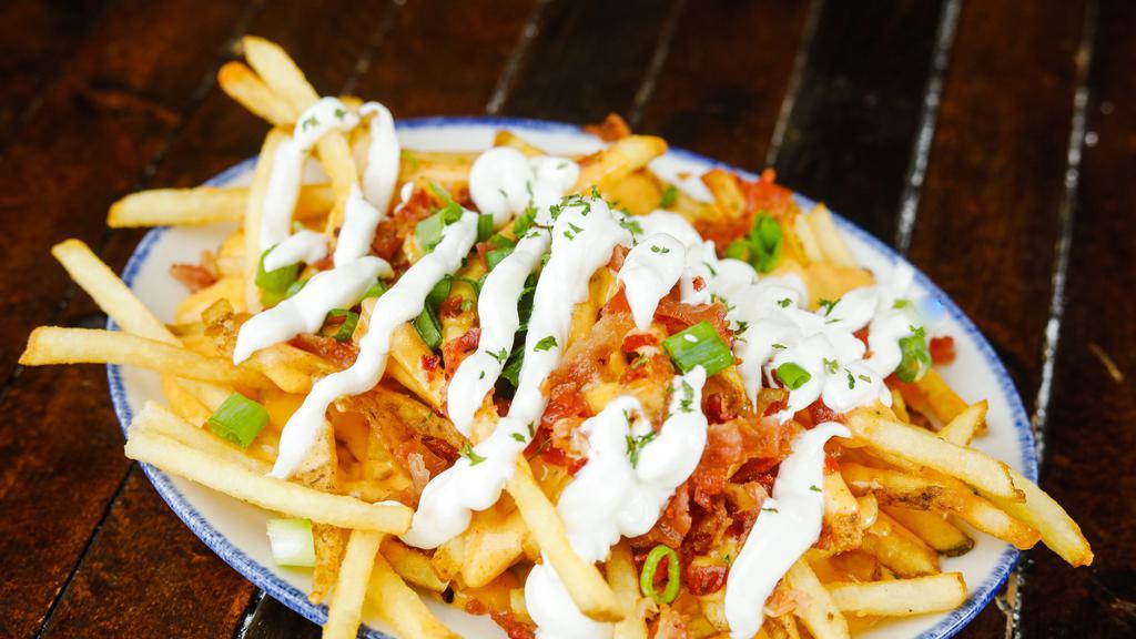 Loaded Fries · French fries topped with cheese sauce, bacon, chives and sour cream.