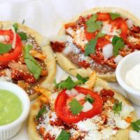 3 Sopes · Three freshly made thick corn tortillas topped with beans, your choice of meat (steak, pasto...
