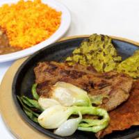 Carne Asada · Grilled juicy steak served alongside two grilled nopales and green onions. Served with rice,...