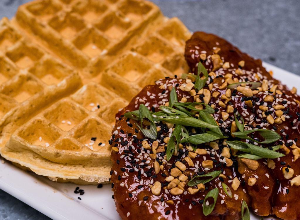 Korean Fried · 3 each 100% Natural Chicken Tenders tossed in Korean Gojuchang sauce piled on a cooked to order Buttermilk Waffle, peanuts, sesame seeds, green onions