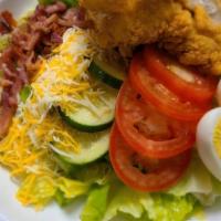 Cobb Salad · Crisp Romaine topped with Hard Boiled Egg, Tomato, Crispy Onions, Cheddar Cheese, Cucumbers,...