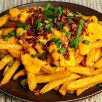 Loaded Fries · French fries with cheddar cheese sauce, bacon bits and scallion served with ranch or blue ch...