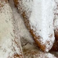 Beignets · Fried dough with powdered sugar.