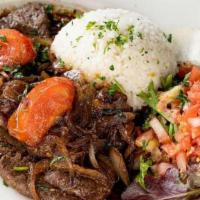 Higado Encebollado · Perfectly cooked liver steak topped with grilled onions. Served with white rice, red beans, ...