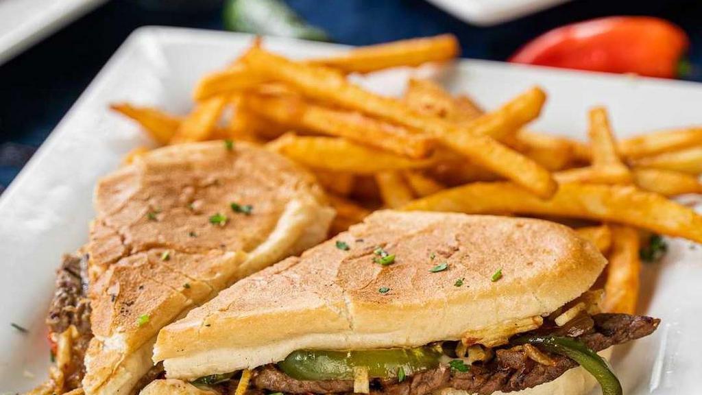 Pan Con Bistec · Palomilla Steak sandwich grilled with onions, peppers, tomatoes, and potatoes stick, put together on cuban bread.