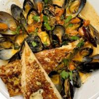 Fresh Mussels · Sauteed in a white wine-chipotle sauce.. Served with garlic toast for dipping.