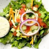 Traditional Side Salad · Crisp romaine lettuce, diced cucumbers, tomatoes, red. onions and garnished with shredded ch...