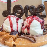 Belove Waffle · Belgian waffle with vanilla ice cream on top, red berries preserves, and chocolate decoration.