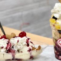 Banana Split · Three scoops of ice cream with variety of sauces and preserves, banana pieces & whipped cream.