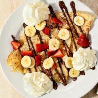 Nutella Fruits Crepe · Nutella, strawberries, bananas, and whipped cream.