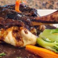 Pan Fried Pork Chops · In port wine sauce, served with rice and vegetables.
