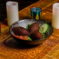 Fried Kibbeh · Meat and crushed wheat shell, stuffed with pine nuts, onions and minced meal.