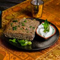 Baked Kibbeh · Meat and crushed wheat shell, stuffed with pine nuts, onions and minced meat baked in the ov...