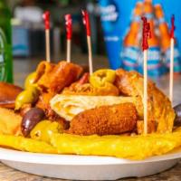 Picada Criolla & 6 Pk Beer Combo · Beef file till, chicken strips, ham ad chicken croquette, pork chunks, green plantains, and ...