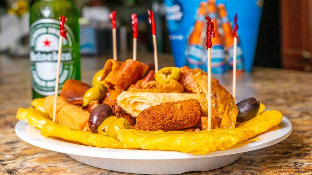 Picada Criolla & 6 Pk Beer Combo · Beef file till, chicken strips, ham ad chicken croquette, pork chunks, green plantains, and chicken taquito & 6 pk cold beer of your choice below