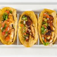 Fish Tacos (3) · Marinated in lemon with diced onion, tomatoes, cilantro and cucumbers.