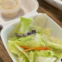 House Salad · Mixed greens and lettuce with ginger dressing.