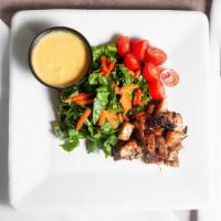 Jerk Chicken Tropical Salad With Mango Dressing · Boneless jerk chicken atop romaine lettuce..carrots..tomatoes. Served with our homemade mang...