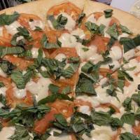 Caprese Pizza · Sliced fresh tomato, fresh mozzarella, basil and olive oil.