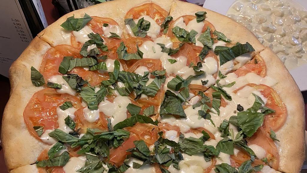 Caprese Pizza · Sliced fresh tomato, fresh mozzarella, basil and olive oil.
