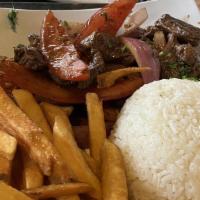 Lomo Saltado · Sauteed filet mignon tossed with French fries, onions, tomatoes, and a soy sauce mixture. Se...