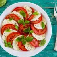 Caprese Salad · Fresh mozzarella, tomatoes, black olives, and lettuce with extra virgin olive oil.