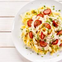 Fettuccine Truffle Pasta · Flat and thick pasta, Italian sausage, portobello mushrooms, white truffle oil, and white cr...