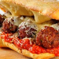 The Meatball Sandwich · Beef meatballs smothered in marinara sauce and Parmesan cheese stuffed in between homemade b...