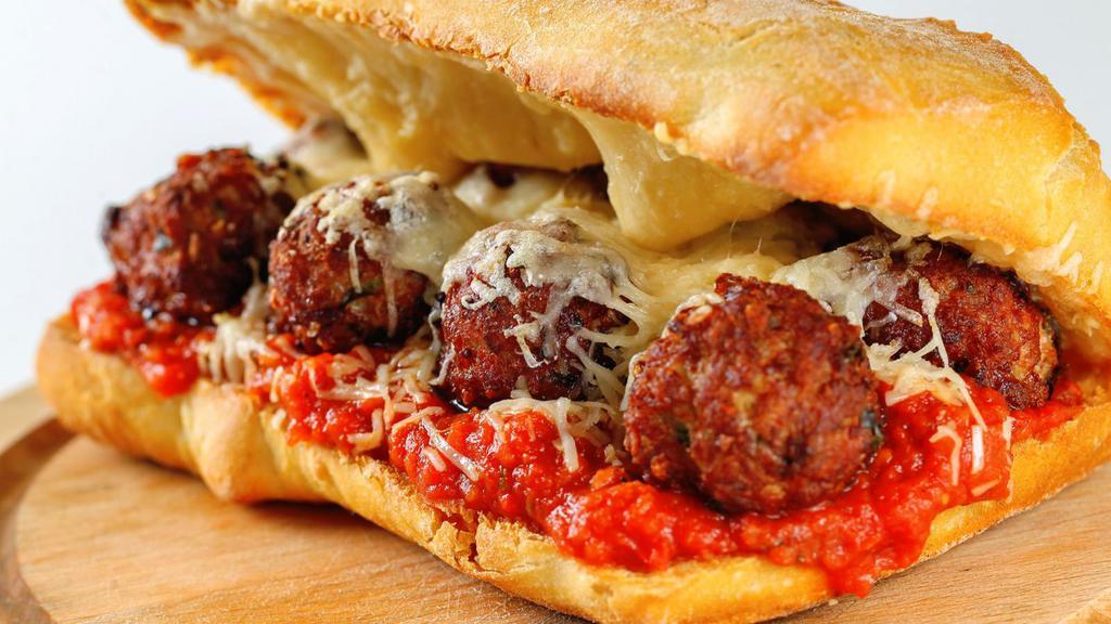 The Meatball Sandwich · Beef meatballs smothered in marinara sauce and Parmesan cheese stuffed in between homemade bread.