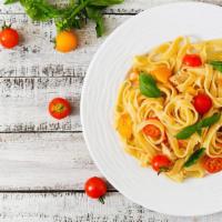 Tomato & Basil Fettuccine Pasta · Flat and thick pasta smothered in homemade tomato and basil sauce.