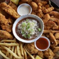 Big Fried Seafood Platter · Shrimp, catfish, oysters, fried gator bites and blue crab claws. Served with fries & hushpup...