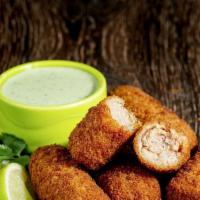 Ham Croquettes (5) · Cuban's favorite. Ground ham cakes breaded and deep fried served with our homemade cilantro ...