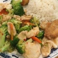 Chicken With Broccoli · Sliced chicken with broccoli and carrot in white sauce.