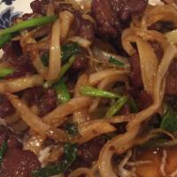 Mongolian Beef · Sliced beef tenderloin with scallions, marinated in ginger sauce and poured over crystal noo...