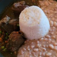 Seco De Res Con Frijoles · Beef stew in a green sauce, served with salsa criolla, rice and canary beans.