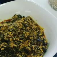 Egusi · Spinach stew thickened with ground melon seeds cooked in
red oil with pepper, dry kinney fis...
