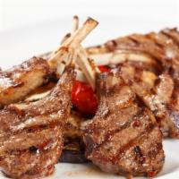 Grilled Lamb · Lamb marinade and grilled, with onions, bell peppers and with and vegetables served with yel...